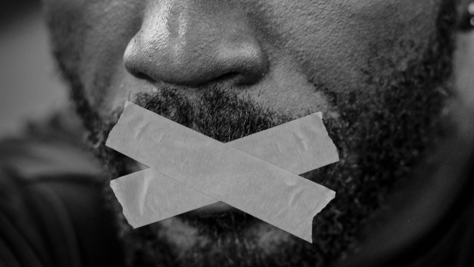 Man with tape over mouth