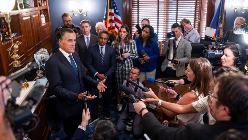Mitt Romney addressing reporters following his retirement.
