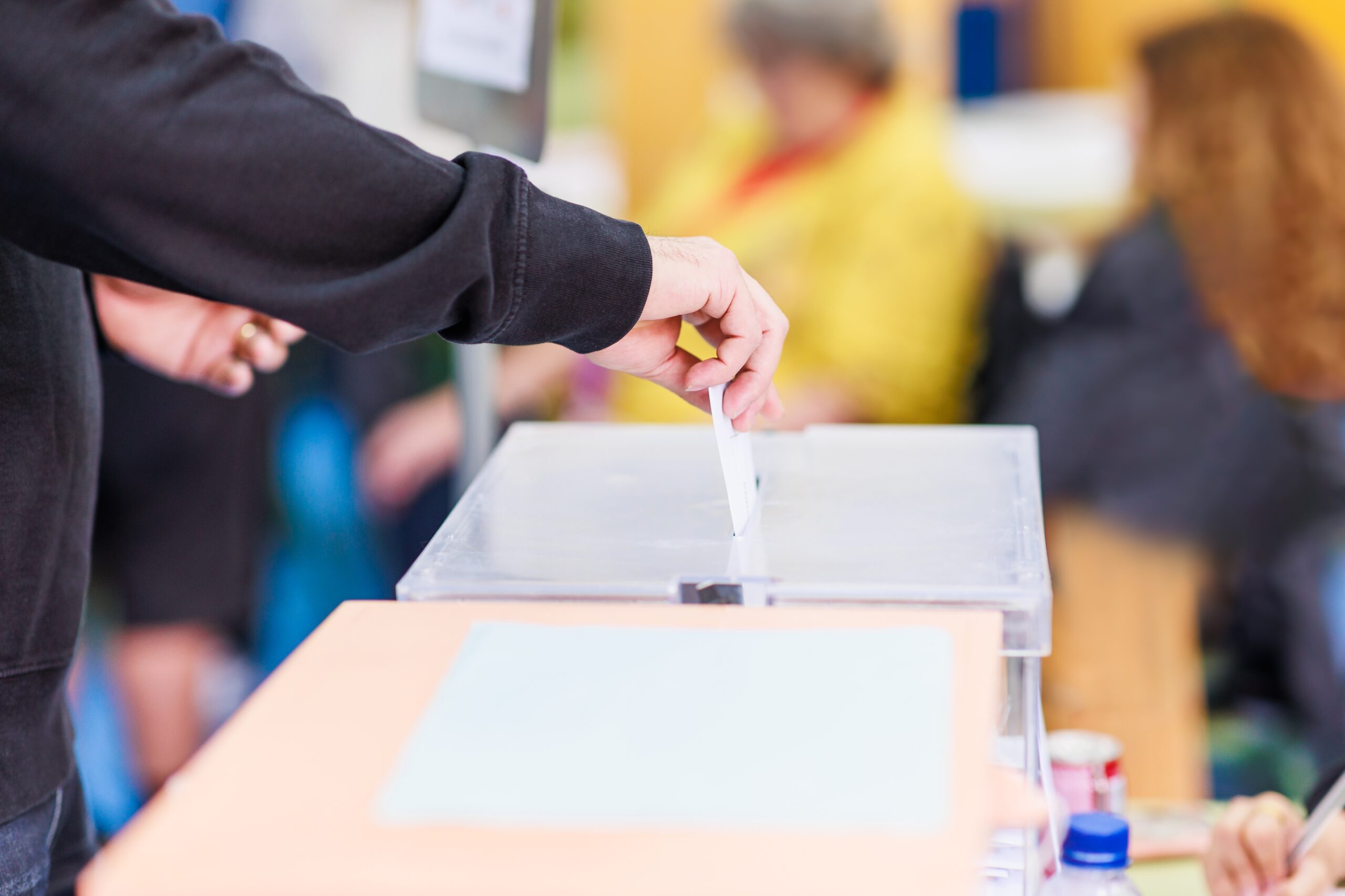 A hand casting a ballot.