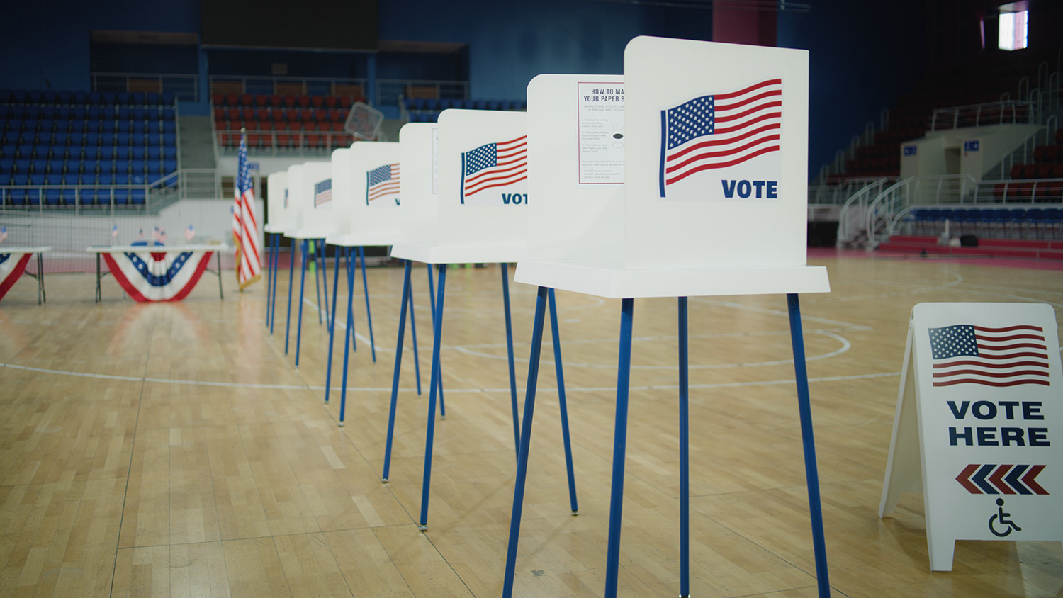 Voting booths set up in a gymnasium.