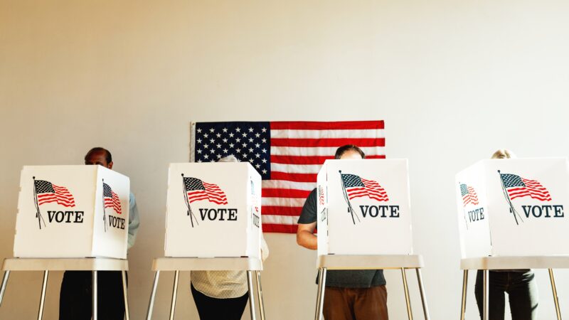 Voters voting in separate voting booths