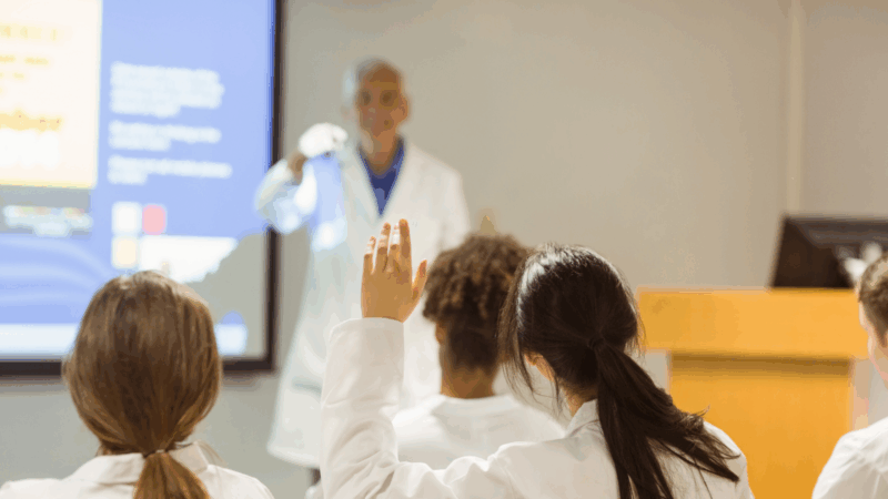 A professor calling on a student in a science class.