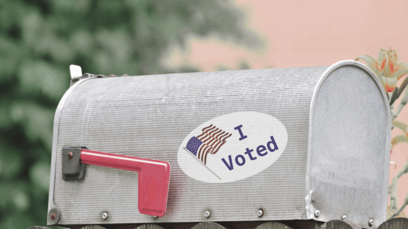 An I Voted sticker on a mailbox.