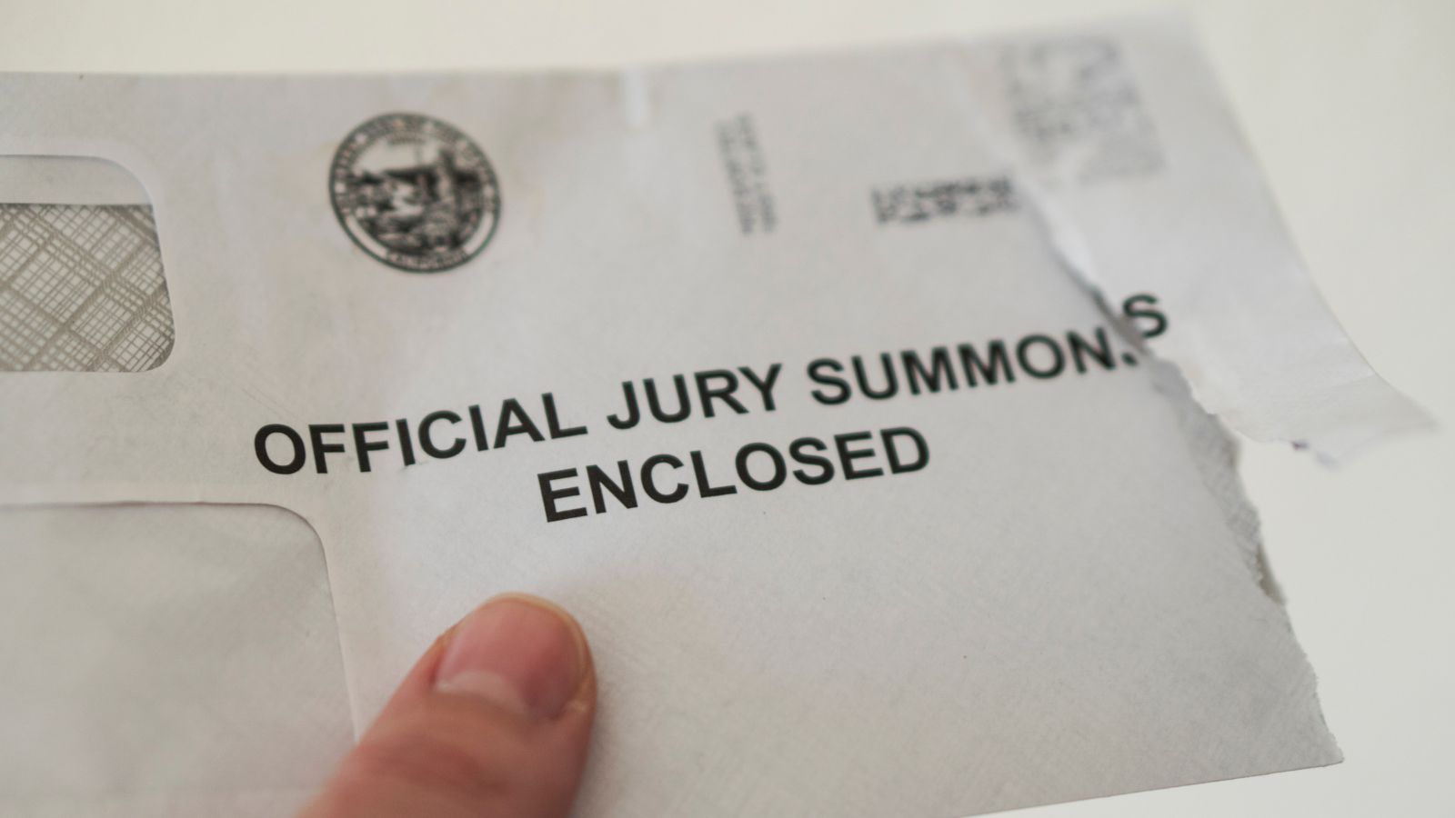 A grand jury summons after being torn open.
