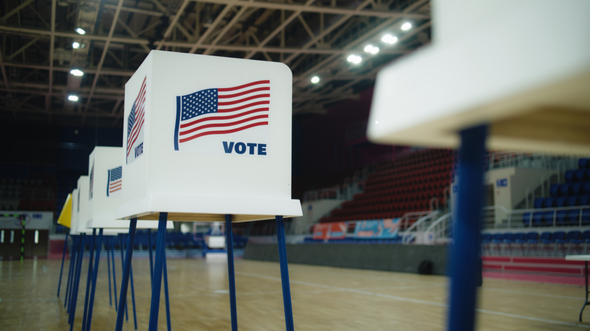 Voting booths lined up in a gym.