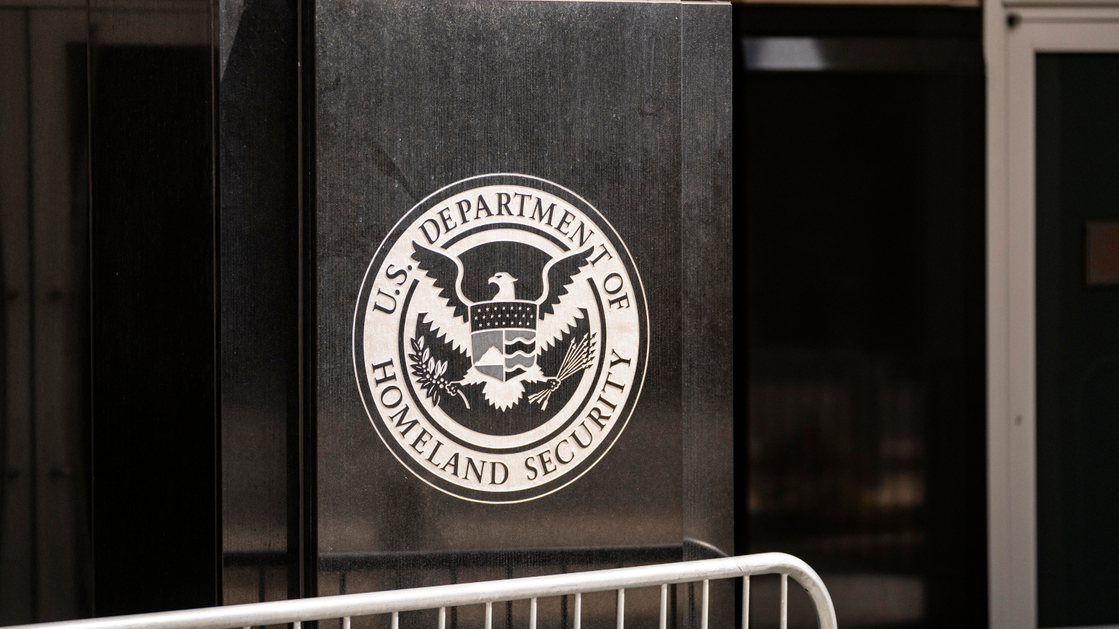 The DHS logo on the side of the DHS headquarters.