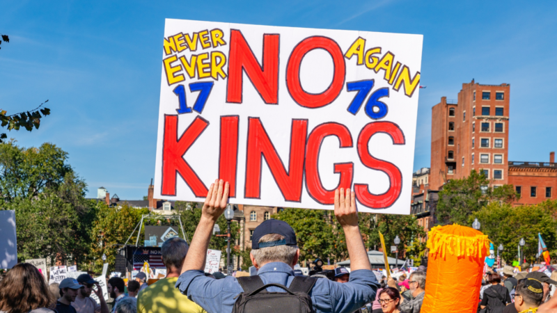 A protester holding a No Kings sign in Boston in October of 2025.