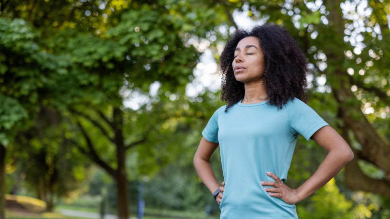 A woman practicing mindfulness outside