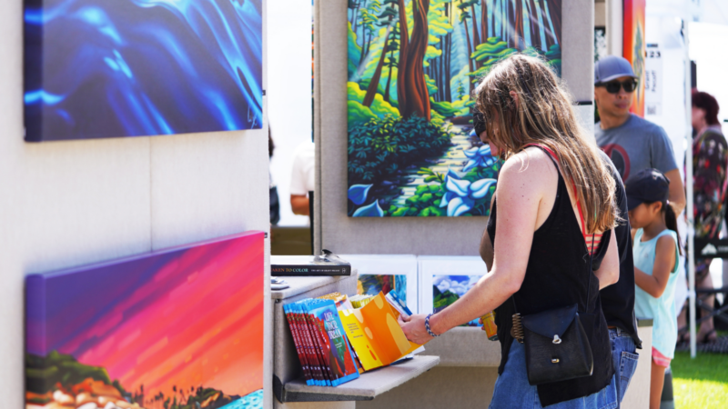 A person looking at art in San Diego during an art fair.
