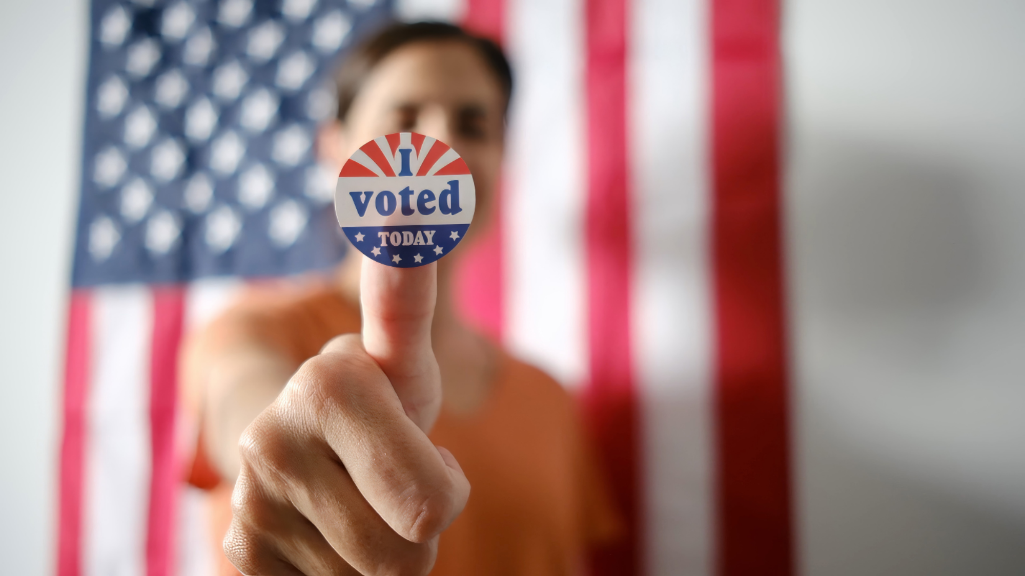 Person holding a voting sticker