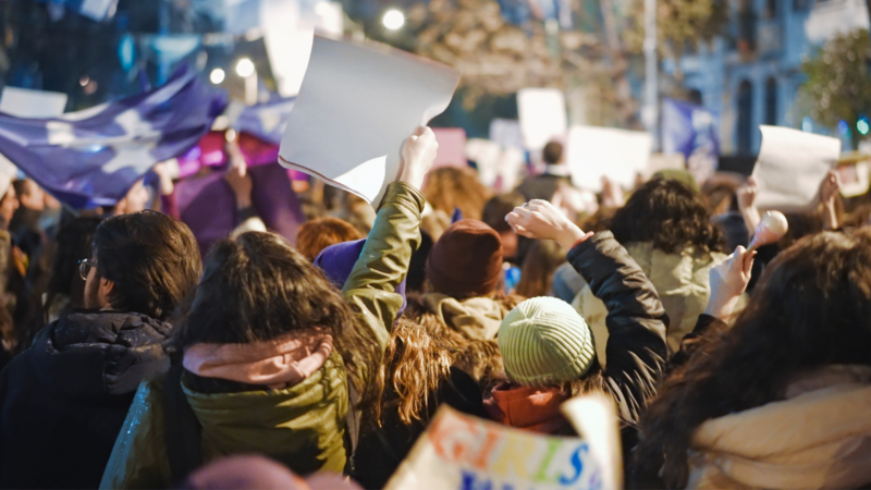 Protesters in coats from behind