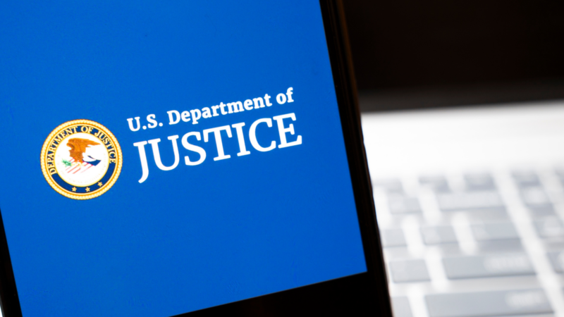 The U.S. Department of Justice logo on a screen.