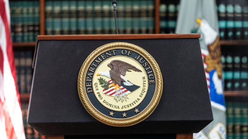 DOJ insignia on a podium