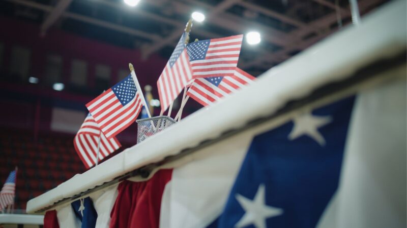 American flags in a cup on a desk