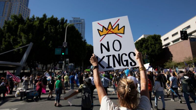 No kings protest sign in front of a crowd