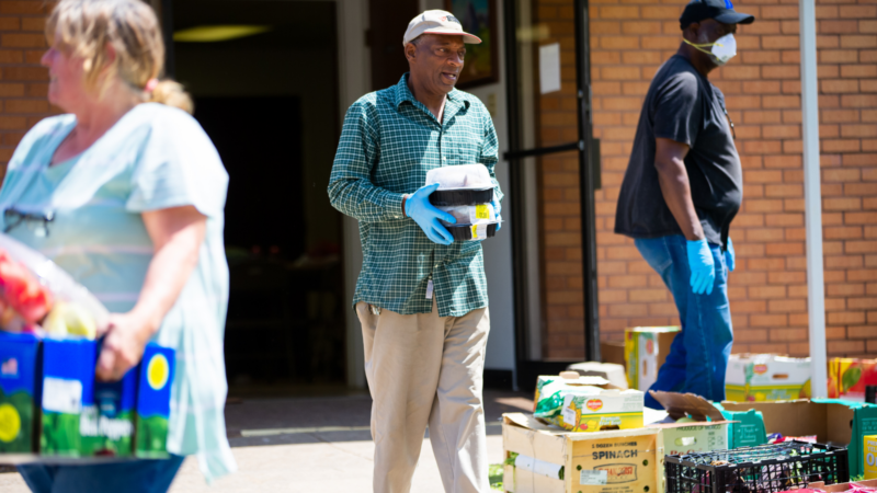 Volunteers working with meals on wheels carrying food