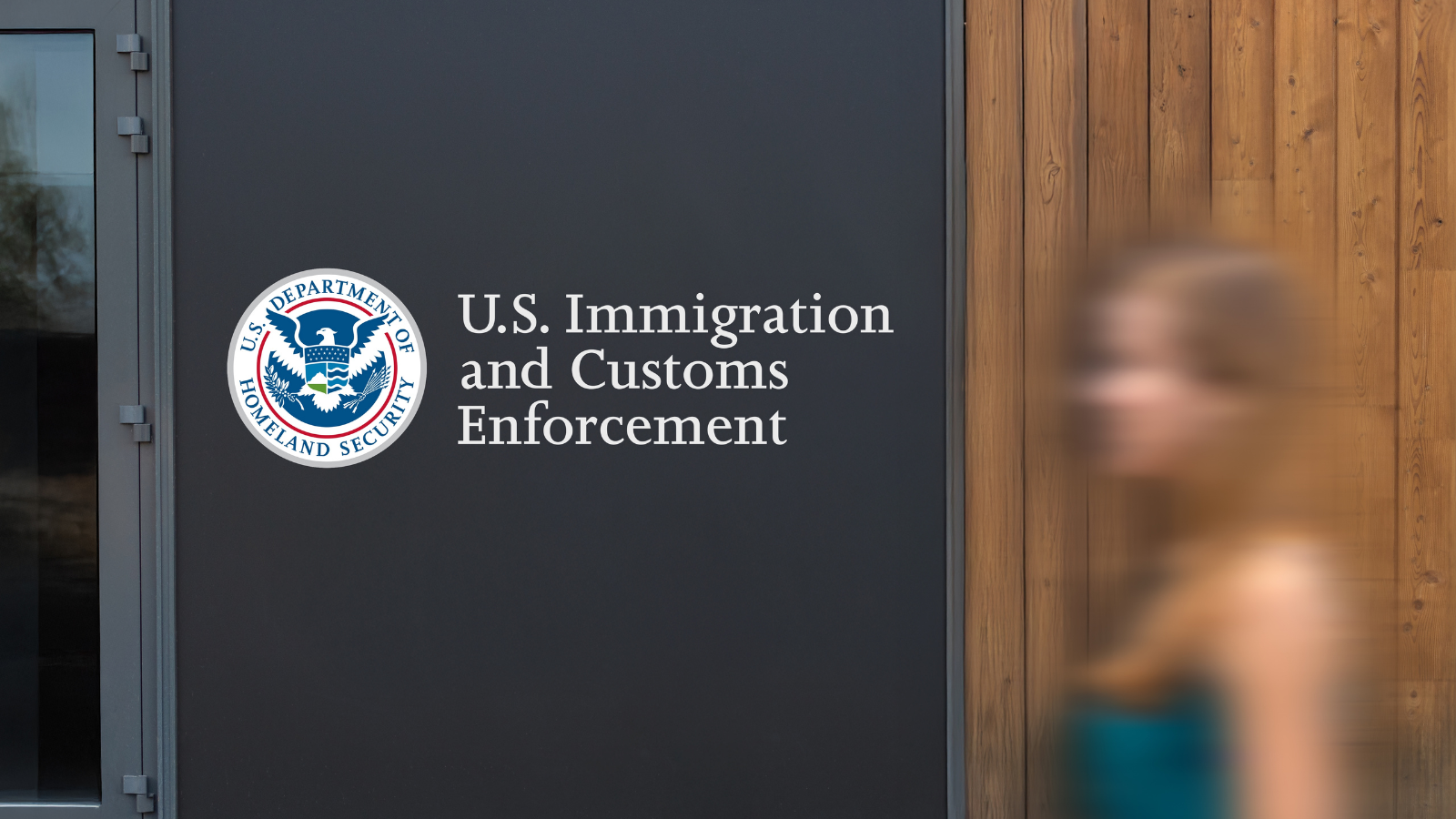 An ICE office with a person walking by it