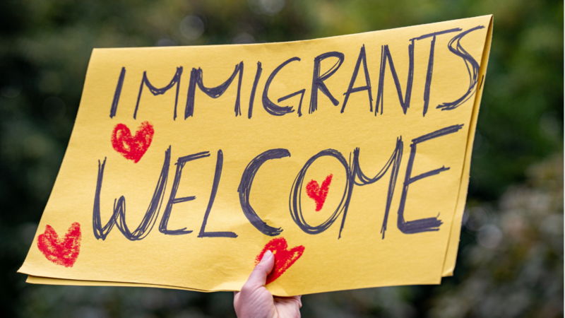 Immigrants welcome sign at a protest.
