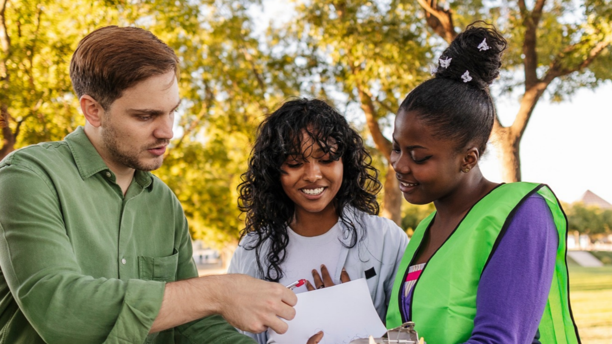 Three people signing a petition together